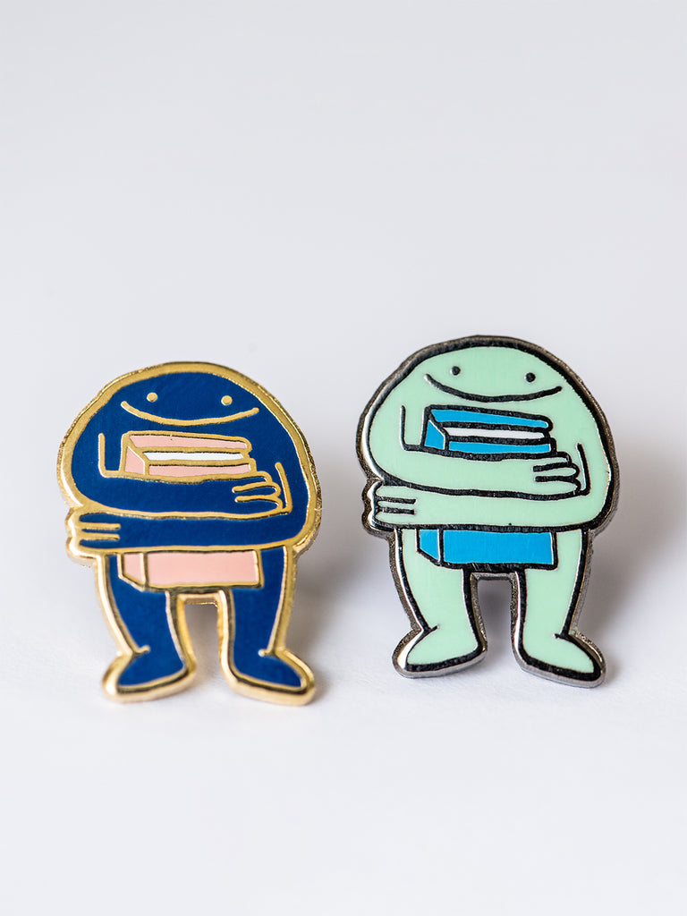 Book Hugger Enamel Pin by Eric Rosario